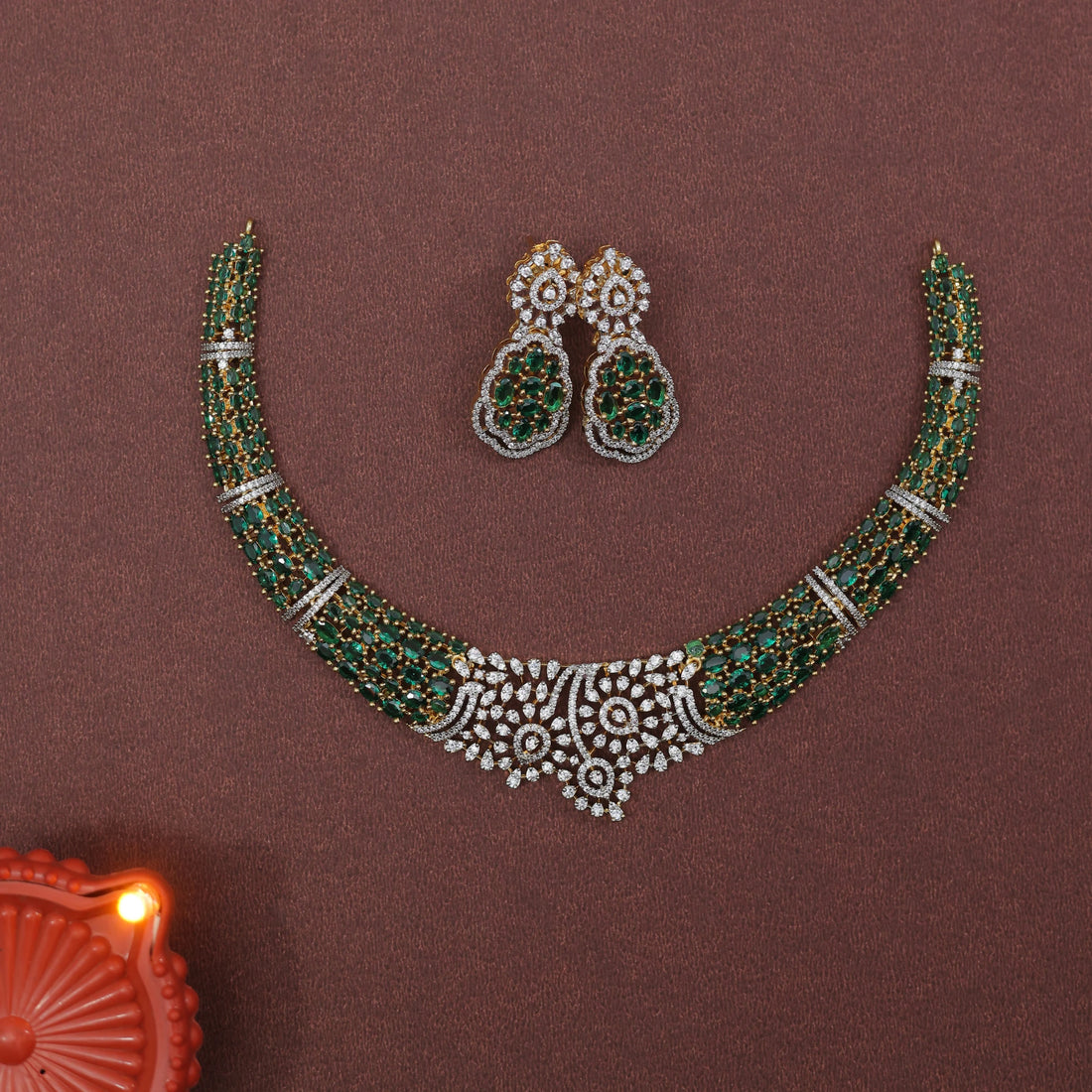 Jewelry set with necklace and earrings on a brown background